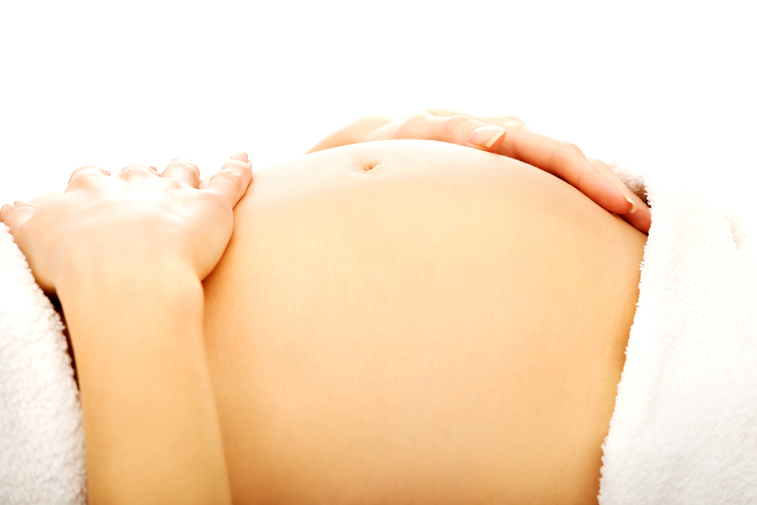 Pregnant woman massagin her belly